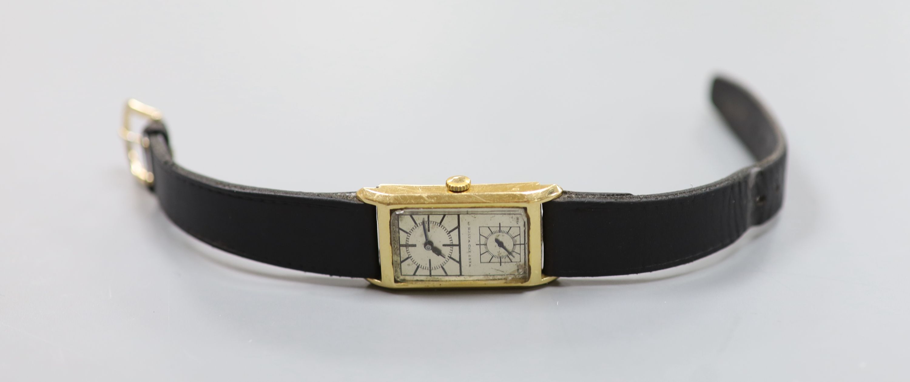 A gentleman's 1940's/1950's 18k West End Watch Co. manual wind rectangular split dial wrist watch, on associated leather strap